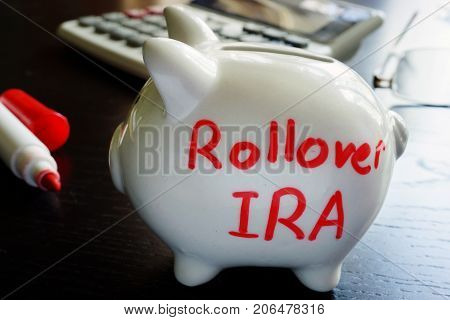 Rollover IRA written on a piggy bank.