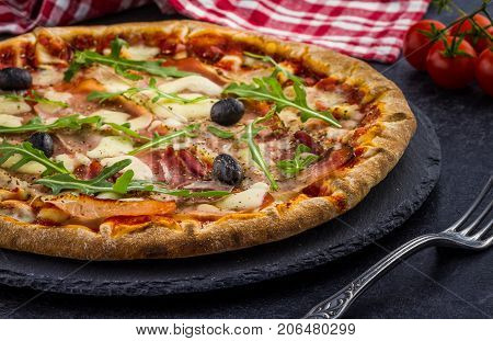 Pizza Tomato ham salad on dark background