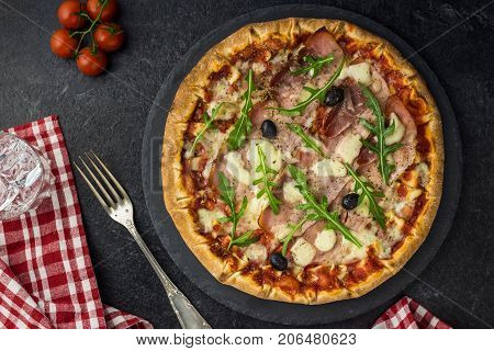 Pizza Tomato ham salad on dark background