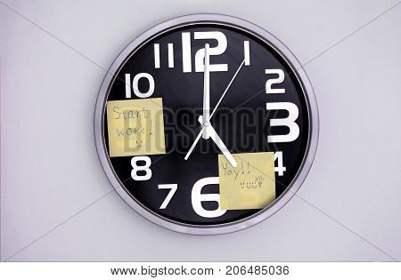 Wall Clock in a Office with a Note Over Nine and Five