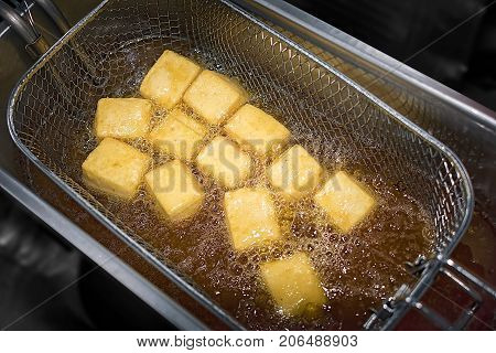 Deep Frying Bean Curd Tofu in the Metal Frying Basket
