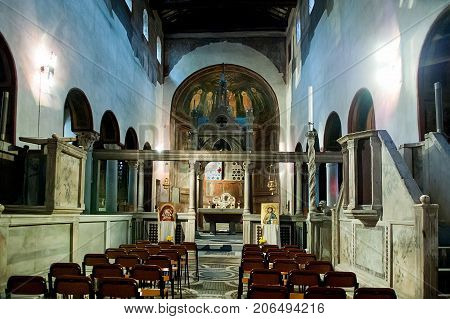 Rome Italy - October 31 2012: Interior view of church of Santa Maria in Cosmedin. The Mouth of Truth is a marble mask in Rome Italy which stands against the left wall of the portico of the church