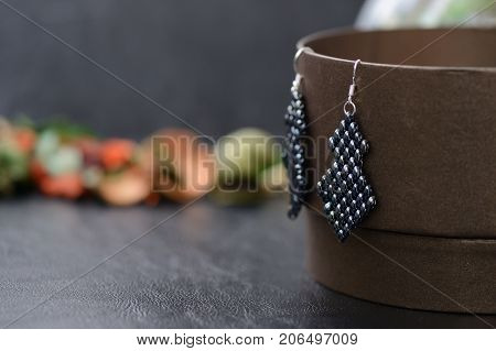 Black Beaded Earrings Hematite Color On A Dark Background