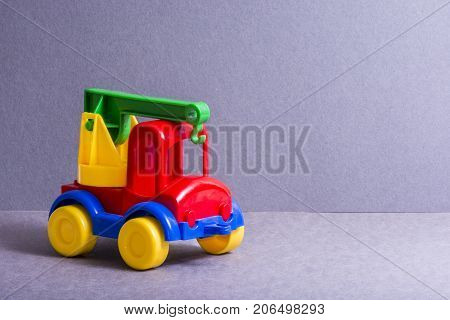 Toy truck. Toys for little children. Bright colors car. Crane.