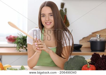 Young  woman is making online shopping by tablet computer and credit card. Housewife found new recipe for  cooking in a kitchen.