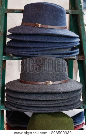 Close-up of stack of fashion female wool hats gray and blue colors.