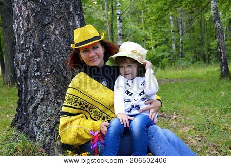 family mom and daughter resting in the forest
