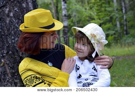 family mom and daughter resting in the forest