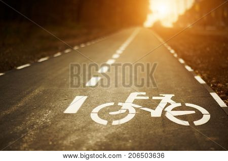 low angle bike lane sign on cycleway at sunset