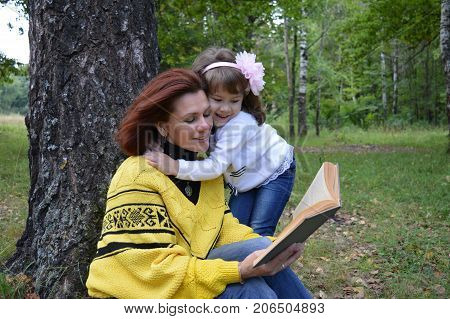 family mom and daughter resting in the forest