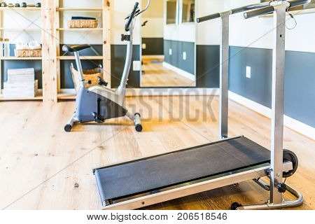 Home Gym With Treadmill, Mirror And Bicycle Machine With Sunlight Coming Through Window In Home, Apa