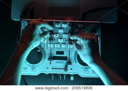 DJ mixer disco illuminated by floodlights at the club