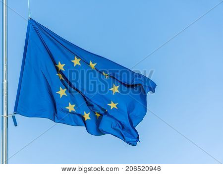European Union flag flying in front of bright blue sky