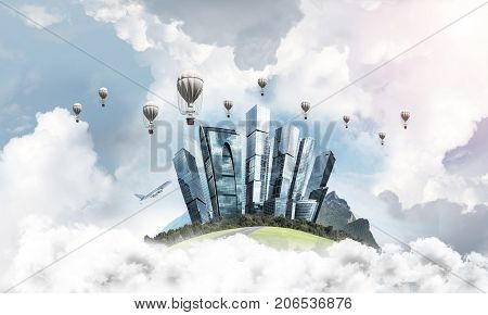 Green flying island among clouds with urban view of towers and skyscrapers. Flying aerostates and blue cloudy skyscape on background. 3D rendering.