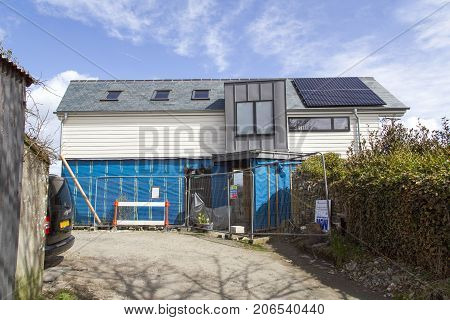 Cornwall, UK: April 14, 2016: A self build detached house during development. An eco-friendly design with solar panels. Self build is possibly the most inexpensive way to attain a large detached home.