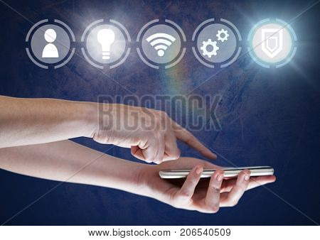 Digital composite of Hand holding phone with icons interface of internet of things