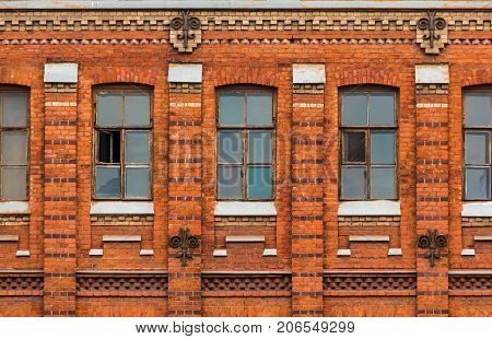 Several windows in a row on facade of urban apartment building front view St. Petersburg Russia