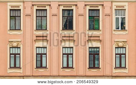 Several windows in a row on facade of urban apartment building front view St. Petersburg Russia