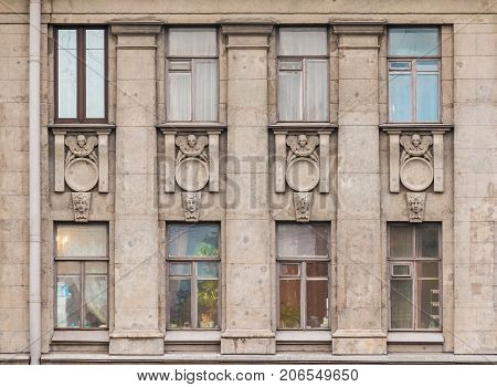 Several windows in a row on facade of urban apartment building front view St. Petersburg Russia