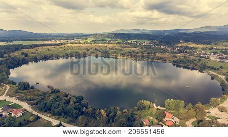 Aerial view of a lake. Clouds reflecting in water.