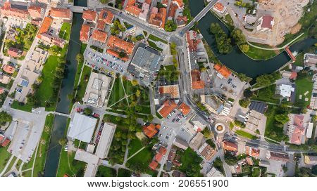 Top view of a river bend running through town. Kocevje, Slovenia.