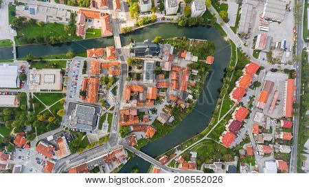 Top view of a river bend running through town. Kocevje, Slovenia.