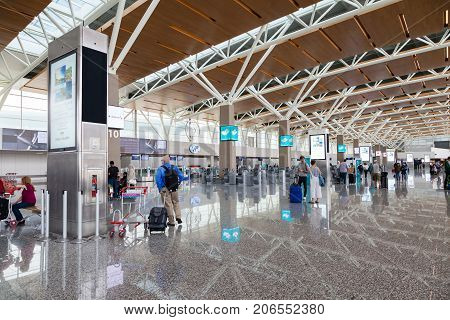 CALGARY CANADA - AUGUST 30 2017: Passengers at the international terminal of Calgary International Airport. Opened in 1938 the airport offers non-stop flights to major cities in North America Europe and East Asia.