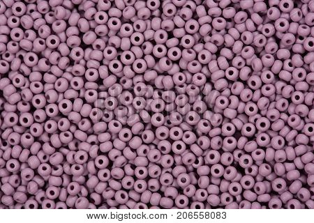 Background of purple seed beads.  High resolution photo.