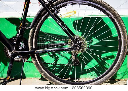 Rear bicycle wheels near the white wall
