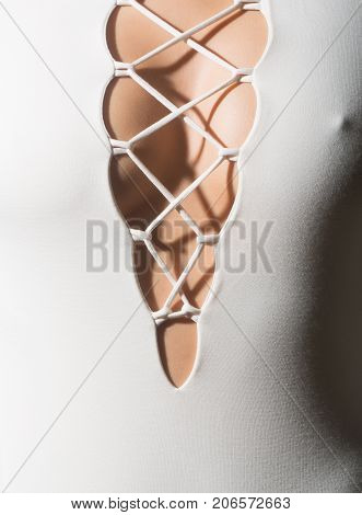 Sexy woman's breasts and nipples through the elegant neckline on the white woman's dress. sensual wedding dress without bra and underwear or lingerie. The shadow of the laces on female breast