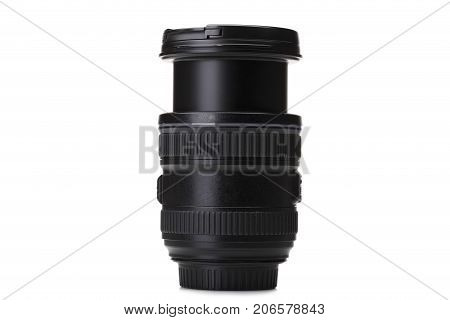 A close-up picture of a black zoom lens isolated on a white background. A professional instrument for taking qualitative photographies. Electronic equipment for photographers. Technology concept.