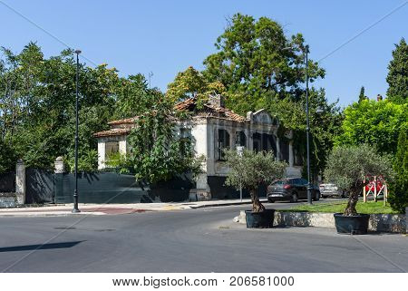BURGAS BULGARIA - AUGUST 20 2017: The street of the seaside city. Half-ruined one-story house. Burgas is the second largest city on the Bulgarian Black Sea Coast.