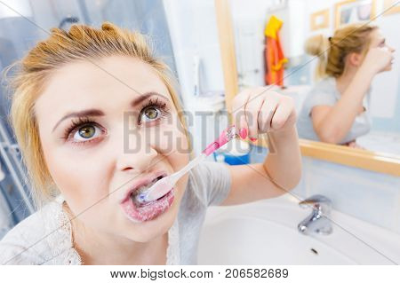 Woman Brushing Cleaning Teeth In Bathroom