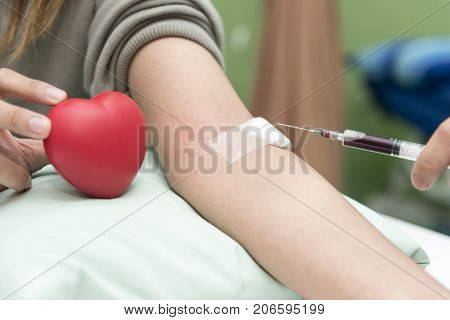 Blood collect by nurse in the hospital with red heart Blood test examination and donate concept. Hospital and health care concept
