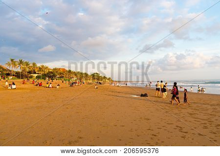 People On Kuta Beach, Seminyak, One Of Popular Attractions In Bali, Indonesia
