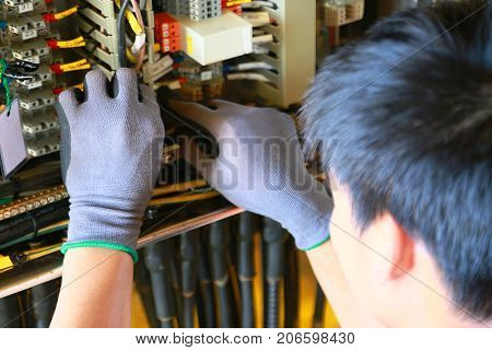 Electrical terminal in junction box and service by technician. Electrical device install in control panel for support program and control function by PLC. routine visit check equipment by technician.