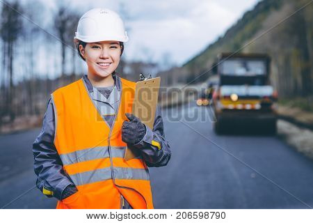 female worker road construction infrastructure repair pavement