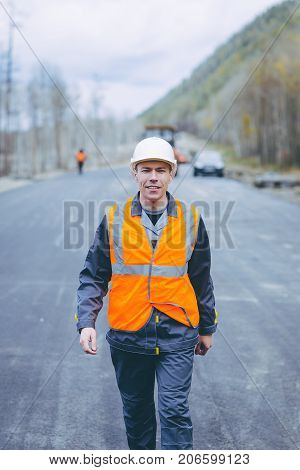 male worker road construction infrastructure repair pavement