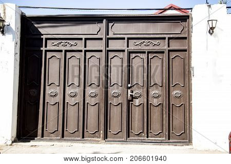 Iron gate to the entrance to the garden and the house