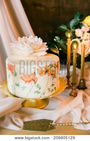 Frowers, candles and wedding painted cake. Still life