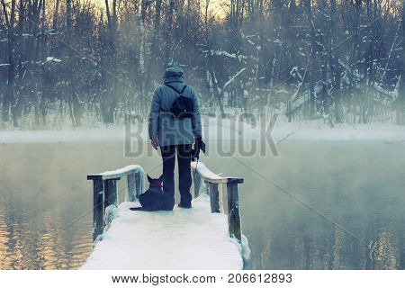 man with black dog. xtreme tourism survival concept