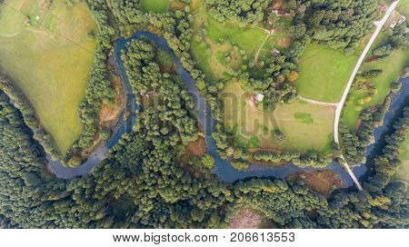 Aerial view of river bend through forest. Rinza near Kocevje, Slovenia.