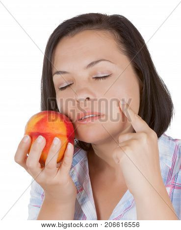 Perfect Skin Concept. Beautiful Girl Holding a Peach Near Her Face on a white background