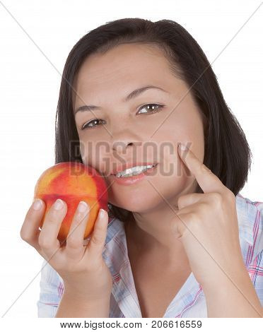 Perfect Skin Concept. Beautiful Girl Holding a Peach Near Her Face on a white background