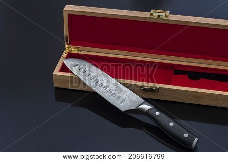 Santoku Kitchen Knife with Elegant Wood Box on Black Reflective Surface