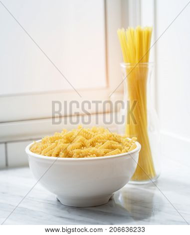 Macaroni in bowl with spaghetti sticks nooddle dinner food restaurant in kitchen room at home modern and mirror
