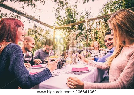 Group of friends at restaurant outdoors - People having dinner in a home garden