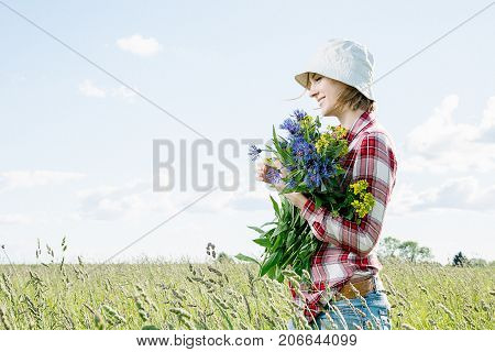 Girl With A Basket Of Flowers In The Field.