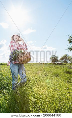 Girl With A Basket Of Flowers In The Field.
