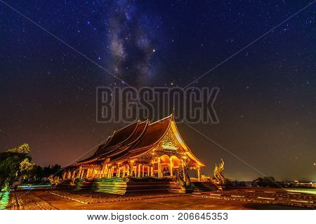Beautiful Sirindhorn Wararam Phu Prao Temple ( Wat Phu Prao ) with spectacular Milky Way background at night Ubon Ratchathani province Thailand